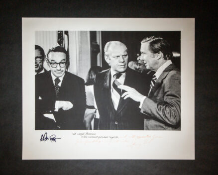 Photograph of President Gerald R. Ford, Senator Lloyd Bentsen and Alan Greenspan, inscribed by President Ford to Senator Bentsen. Additionally signed by Alan Greenspan. This photograph was taken on September 5th, 1974 at the Conference on Inflation, held in the East Room of the White House.