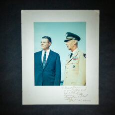 Photograph of Secretary of Defense Robert S. McNamara with Army General Paul L. Freeman, Jr., signed on the mount by McNamara with inscription.