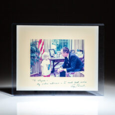 Signed White House photograph of President George H.W. Bush with his granddaughter, inscribed to American businessman, Wayne Huizenga.