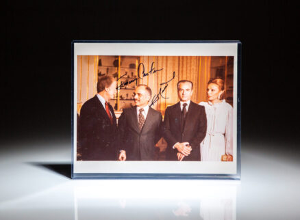 Signed photograph of President Jimmy Carter, standing next to King Hussein of Jordan, the Last Shah of Iran, Mohammed Reza Pahlavi, and his wife, Farah Pahlavi.