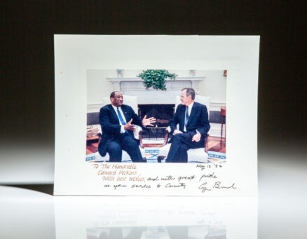 Photograph of President George H.W. Bush greeting the new United States Ambassador to the United Nations, the Hon. Edward J. Perkins. Official White House photograph, dated May 12, 1992 on verso.