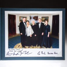 White House photograph of the Bush family, inscribed to Alma Powell, the wife of Secretary of State Colin Powell. The photograph is signed by President George H.W. Bush, President George W. Bush, First Lady Laura Bush and First Lady Barbara Bush.