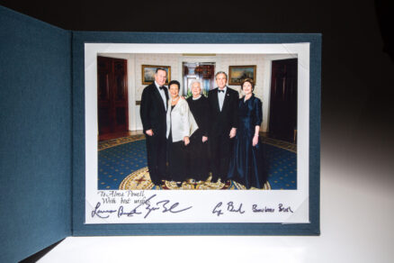 White House photograph of the Bush family, inscribed to Alma Powell, the wife of Secretary of State Colin Powell. The photograph is signed by President George H.W. Bush, President George W. Bush, First Lady Laura Bush and First Lady Barbara Bush.